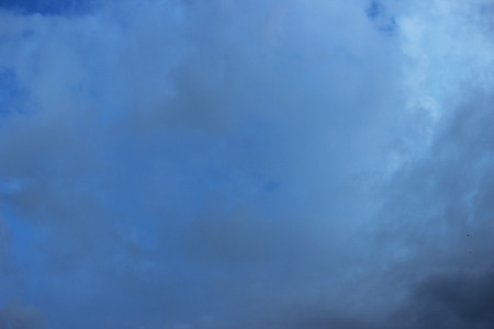 white clouds against the blue sky on a sunny summer dayの写真素材