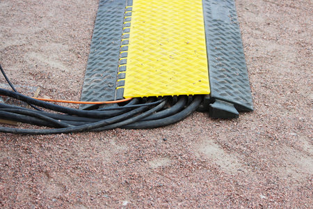 Floor protection yellow black cable many channels with electrical video Belden Snake Cables lies on...