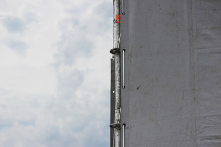 Metal structure in the form of a frame with tent for attaching and protectiving musical columns and soffits in the park on the holiday.の写真素材