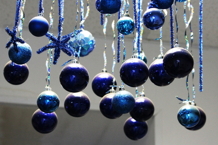 Many blue Christmas-tree toys hang at the ceiling. Christmas decorationの写真素材