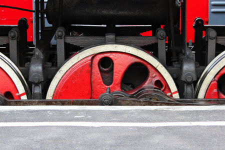 Powerful wheels of old locomotive stands on the railroad tracks on the day of the railwaymanの写真素材