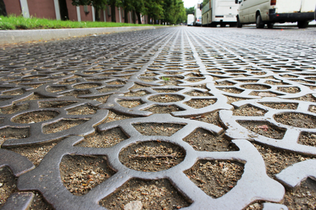 The road in the city of Krondstadt along the fence of the new Admiralty is paved with cast-iron lattice rounded partsの写真素材