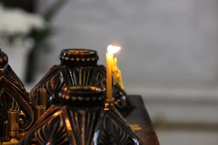One candle in candlestick in the Orthodox Church.