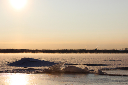 background of fresh white snow winter outdoor on the surface of the river covered with ice. freezing on the river Severnaya Dvina. the beginning of freeze-up and the first broken iceの写真素材