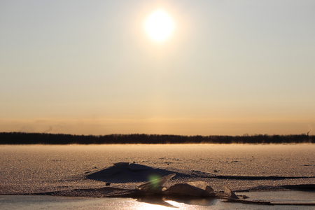 background of fresh white snow winter outdoor on the surface of the river covered with ice. freezing on the river Severnaya Dvina. the beginning of freeze-up and the first broken iceの写真素材