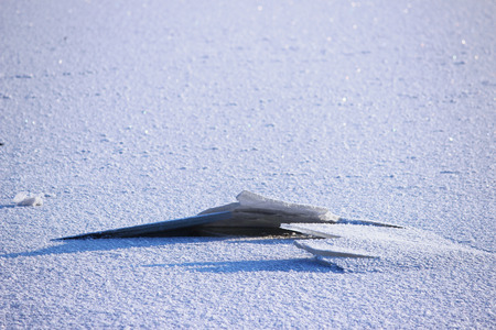 background of fresh white snow winter outdoor on the surface of the river covered with ice. freezing on the river Severnaya Dvina. the beginning of freeze-up and the first broken iceの写真素材