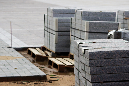 many curbs for construction works on pallets at the site laying paving slabs city square.の写真素材
