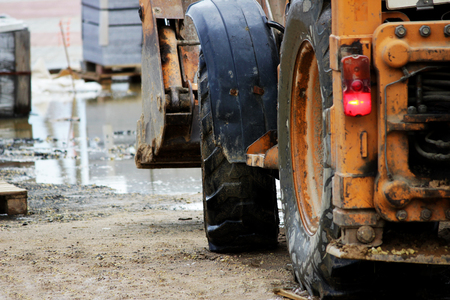 the tractor stands on the site for repairing the area with paving tilesの写真素材