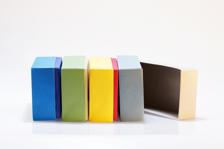 Few colorful paper boxes of colored cardboard for packing bow ties and other gifts on a white background. Hand madeの写真素材
