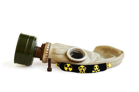 trophies of the stalker: old Russian gas mask, rusty nail and yellow-black baubles on a white backgroundの写真素材