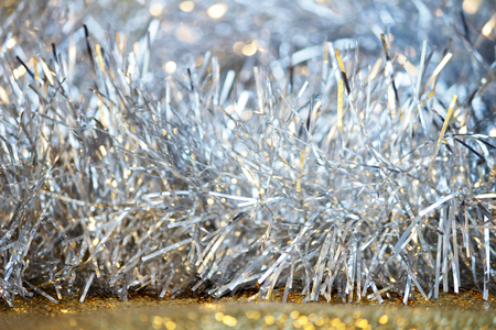 silver tinsel on a gold background for decorating a Christmas festive treeの写真素材
