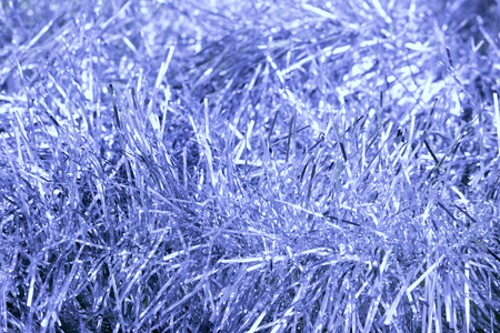 silver blue tinsel on a gold background for decorating a Christmas festive treeの写真素材