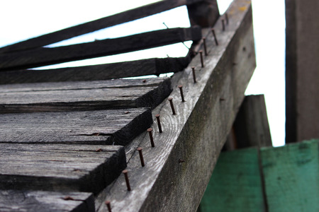 The old wooden canopy protecting people passing by building from falling of building materials from aboveの写真素材