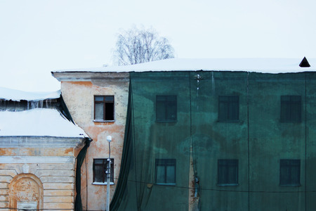 Restoration of the historical old building and a protective green building mesh. Gatchina, Russiaの写真素材