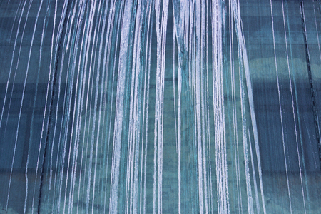 Restoration of the building and a protective green building mesh with frozen water that drained from the roofの写真素材