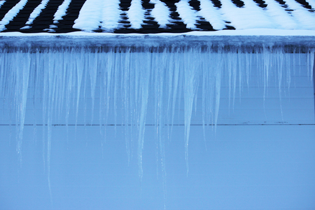 icicles on building roof at spring dayの写真素材