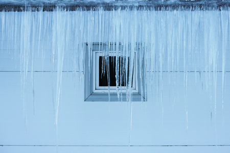 icicles on building roof at spring dayの写真素材
