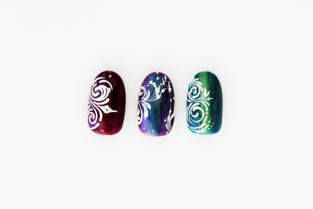 three plastic tips for nail extension and training in applying design while training a manicure on a white background. trial student work in the form of monogramsの写真素材