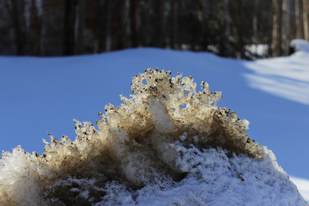 melting dirty snow piled up by a bunch after cleaning the road. Spring.の写真素材