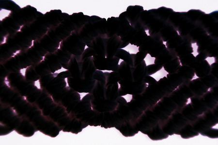 bracelet made by the technique of macrame. waxed thread. reps and flat double knots. macro photography. computer processing. inversionの写真素材