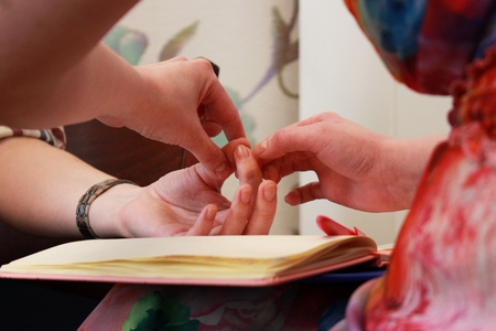 two girls hold hands on a course on teaching esoteric techniques. check the muscle test. passing the basic course on the study of esoteric techniques.の写真素材