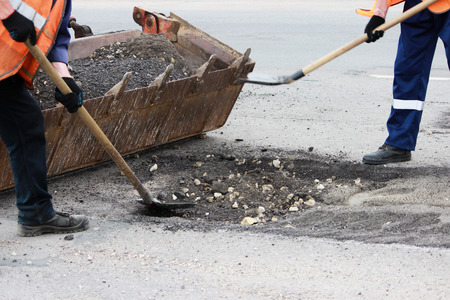 partial road repair with removal of old cover on the site of pits and patchingの写真素材