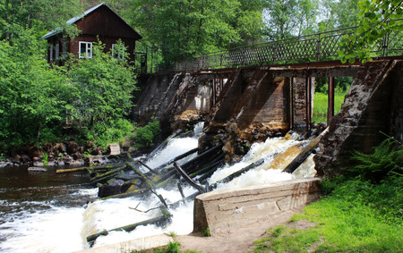 An old dam on the river with stormy water. Leningrad Region, Russia.の写真素材