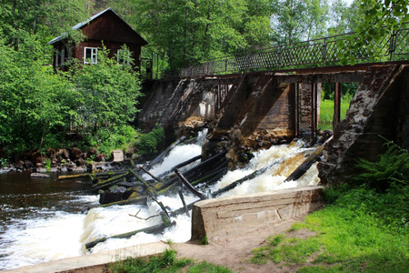 An old dam on the river with stormy water. Leningrad Region, Russia.の写真素材