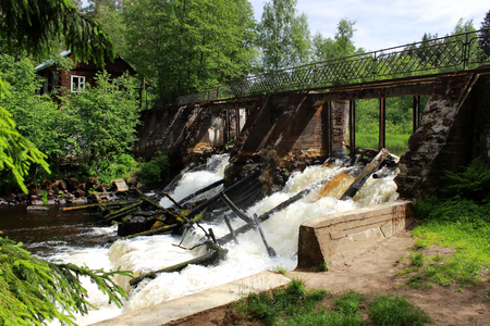 An old dam on the river with stormy water. Leningrad Region, Russia.の写真素材