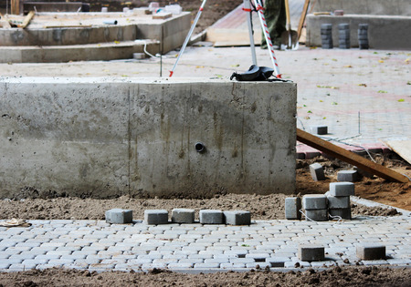 laying paving slabs on city square, repairing sidewalk and squareの写真素材