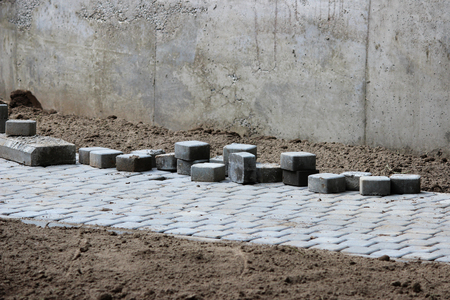 laying paving slabs on city square, repairing sidewalk and squareの写真素材