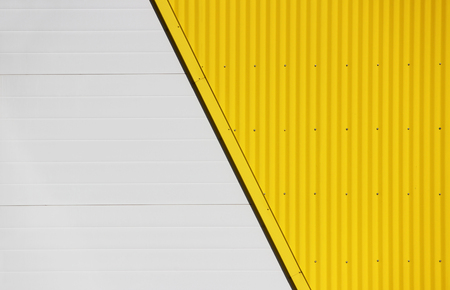 Wall of large shopping center with a beige and yellow backgroundの写真素材