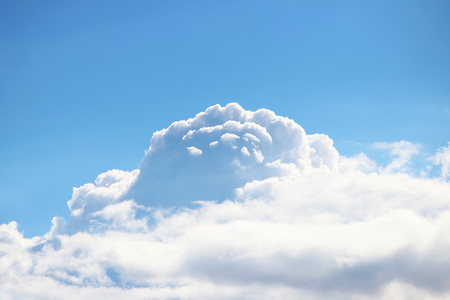 white big clouds against the blue sky on a sunny summer day.の写真素材
