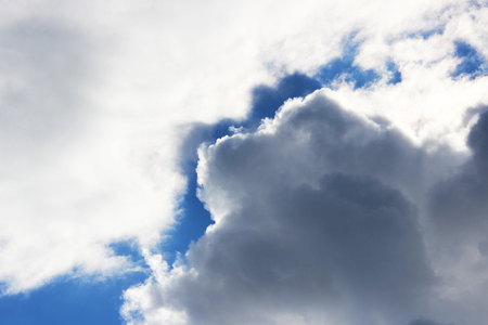white big clouds against the blue sky on a sunny summer day.の写真素材