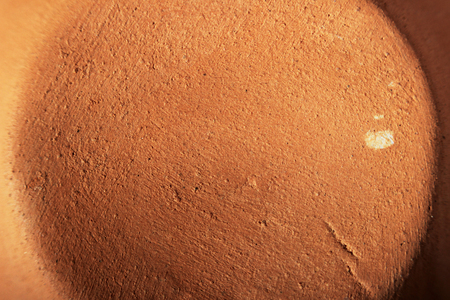 the bottom of a small clay pot, the view from below, macro photography. texture of baked clay.の写真素材