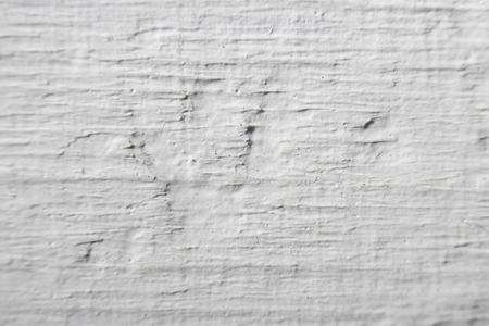 Decorative plaster effect on wall. white plaster lighted by daylightの写真素材