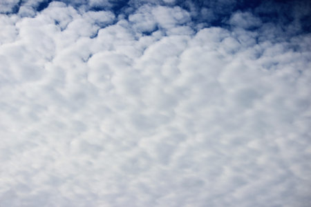 Light white cirrus clouds covering the large surface of the sky.