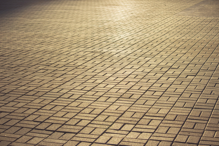pavement laid on the town square, painted by the setting evening sunの写真素材