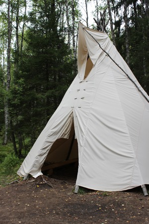 tall wigwam from dense beige fabric in the forest of Karelia.の写真素材