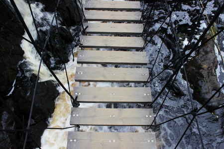 wooden bridge over a small waterfall. Karelia, Ruskealaの写真素材