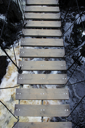 wooden bridge over a small waterfall. Karelia, Ruskealaの写真素材