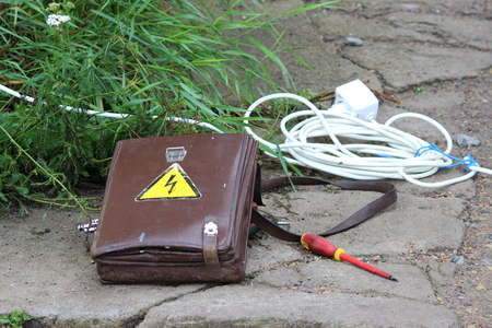 electrician things folder, extension and indicator screwdriver are on the ground. reportage photography, Russiaの写真素材