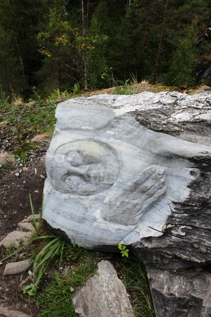 Sculpture, personifying the spirit that blocks the path to a dangerous precipice. Carved from a large piece of marble and lies near the marble canyon, Kareliaの写真素材