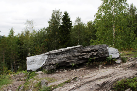 Sculpture, personifying the spirit that blocks the path to a dangerous precipice. Carved from a large piece of marble and lies near the marble canyon, Karelia.の写真素材