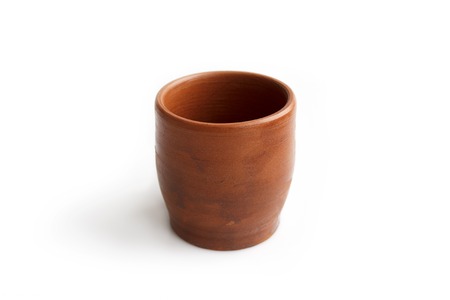 Clay glass, made by hand on a potters wheel from red clay. Double burning. Transparent glaze applied by hand - visible potters fingerprints and brush strokes. Handmade, single copy. White background, isolatedの写真素材