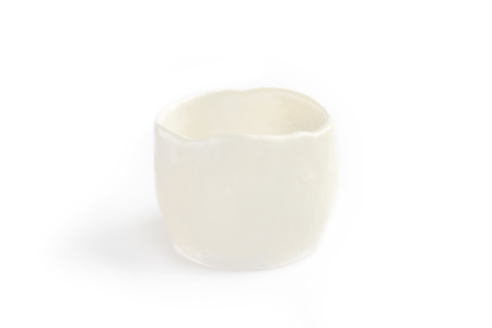 translucent image of clay cup, made by hand from white clay. Double burning. Transparent glaze applied by hand. Handmade, single copy. White background, isolated.の写真素材