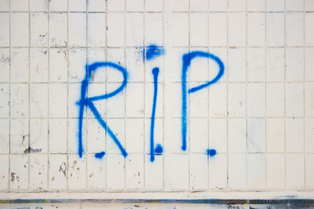 Blue graffiti on the wall of the house. written r.i.p.の写真素材