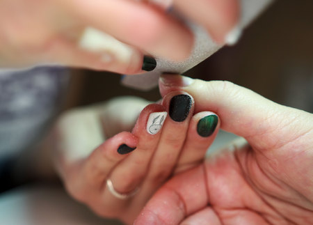 nail service manicurist saws and smoothes clients nails using a file. reportage shootingの写真素材