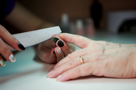 manicure for an elderly woman. the beauty of old age. age skin.の写真素材