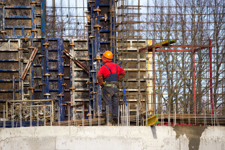 the worker and the crane operator unload the car with reinforced concrete walls for building a large wellness center with a swimming pool of modern technology with concrete poured reinforced and formwork walls. reportage.の写真素材